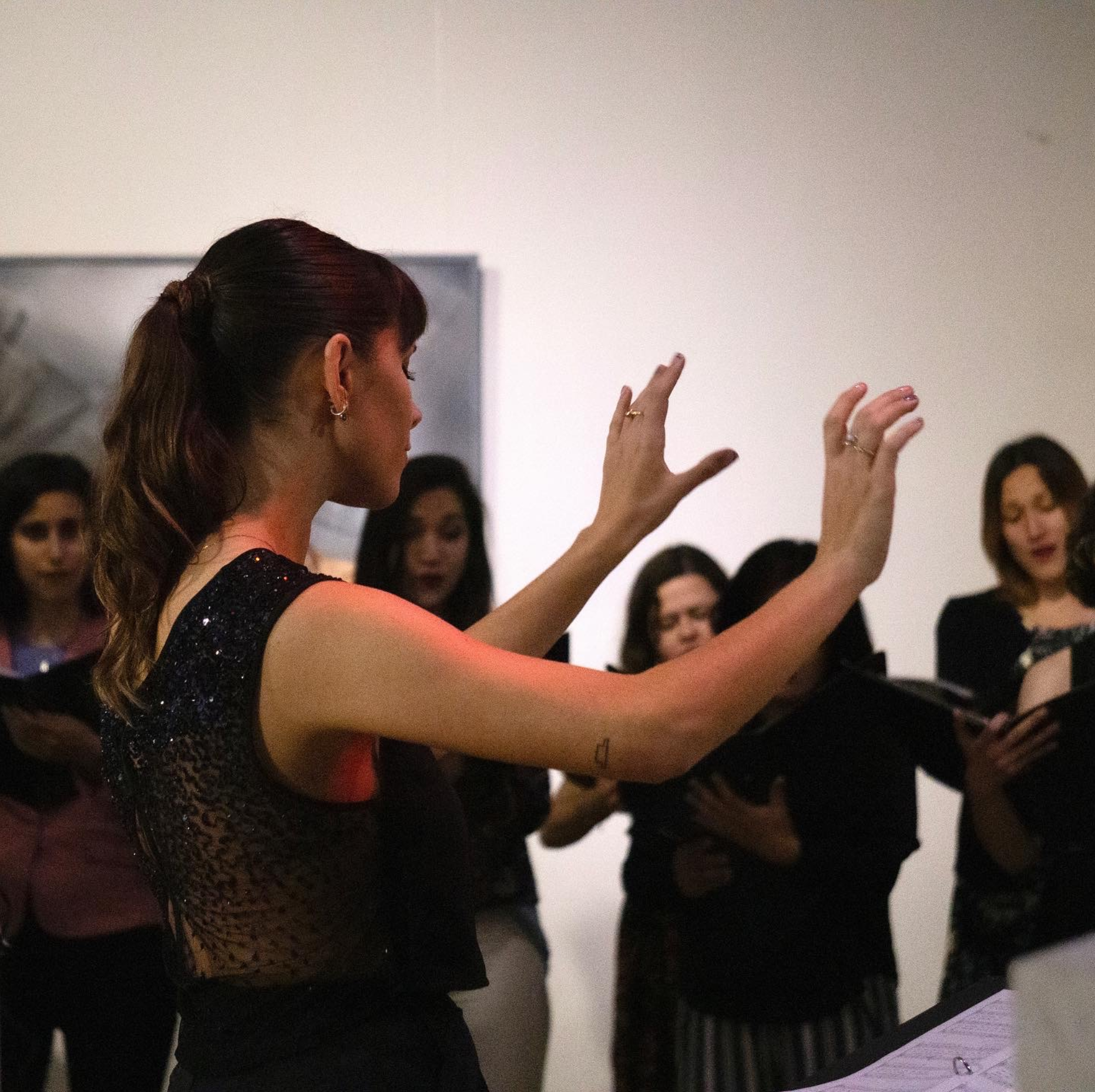 Camila conducting a choir